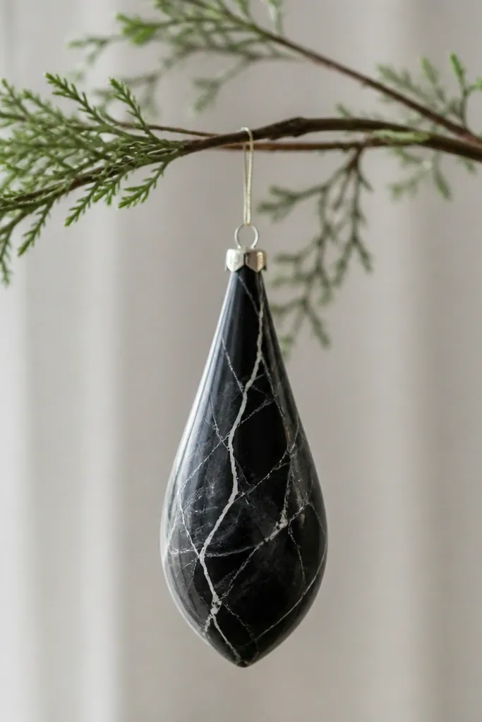 A teardrop ornament painted black with gray veining lines and a few thin white highlights, finished with satin clear.