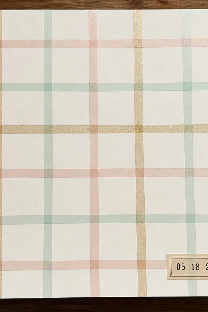 A page covered in a neat washi tape grid with a dark date stamp block
