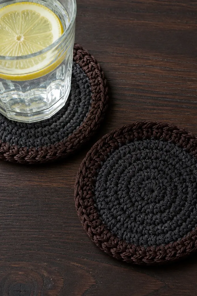 Round crochet coaster with dark edging that looks leather-like