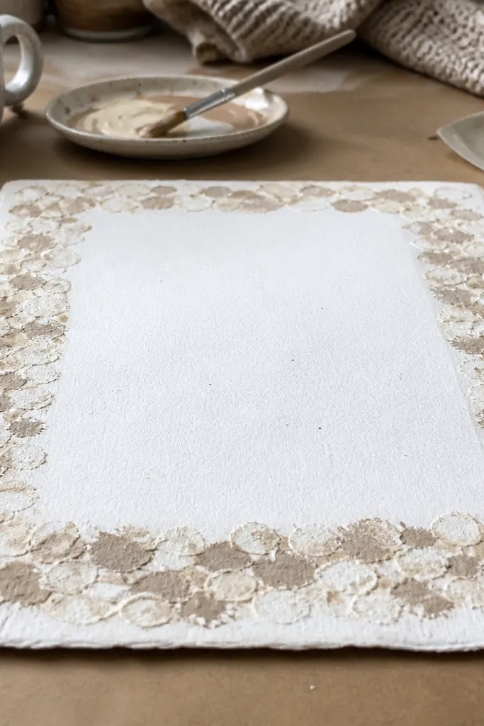Handmade border with repeated sponge dabs like knit texture around a writing box