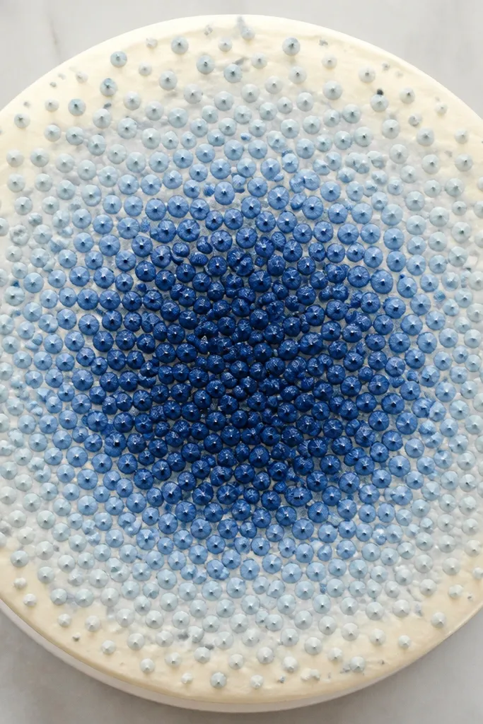 Cake top with dots fading from dark blue to light blue in a gradient circle