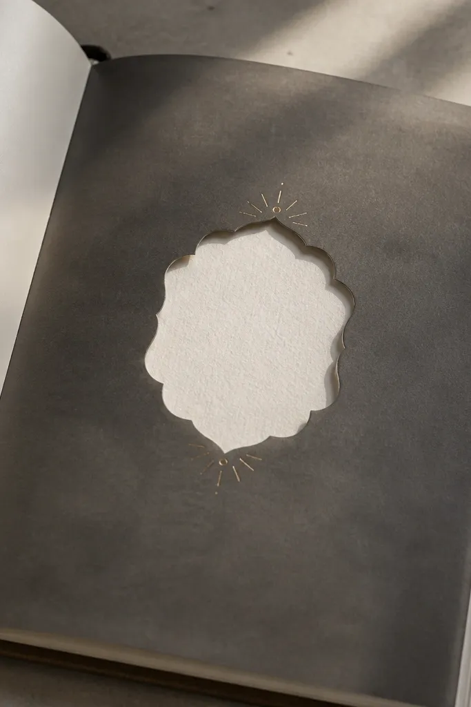 Dark vellum sheet over a journal with a crisp title window and gold corner dots