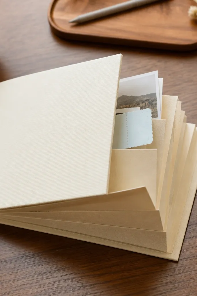 Scrapbook cover with a centered accordion pocket and a tidy front label