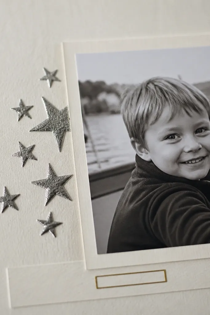 Cream page with embossed star cluster and small metallic foil label