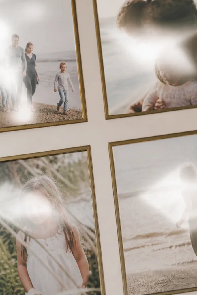 Close-up of a framed photo collage where several frames show bright glare patches from overhead light. The photos look washed out and the glare moves across the images.