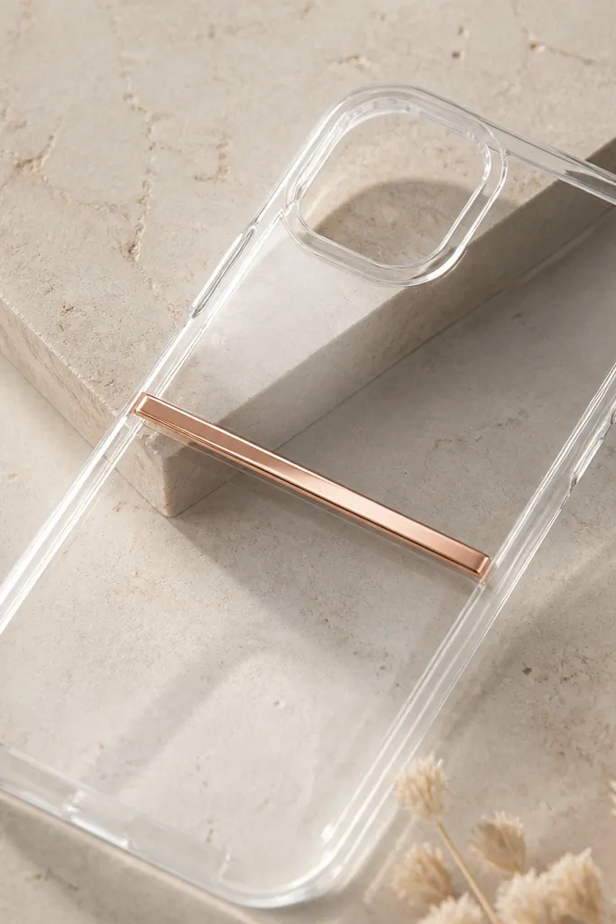 A clear case with a thin rose gold foil strip running horizontally across the center, with a subtle darker resin shadow behind it for depth.