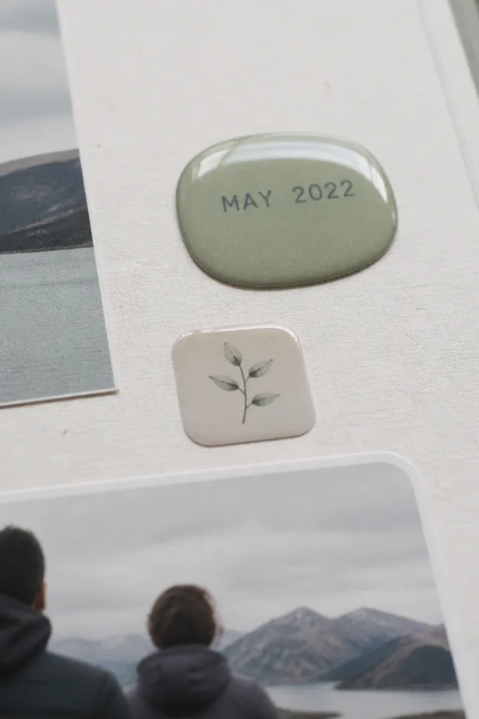 A scrapbook page with glossy label dots and matte photos arranged in a neat grid