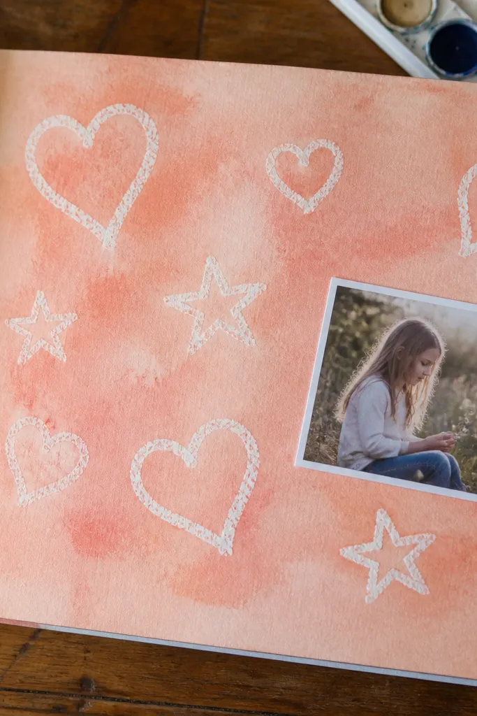Scrapbook page with crayon resist shapes under a soft wash background