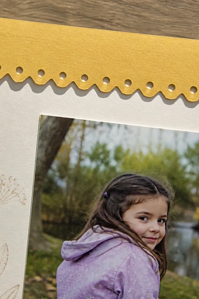 Scrapbook page with a border strip that has punched holes like polka dots