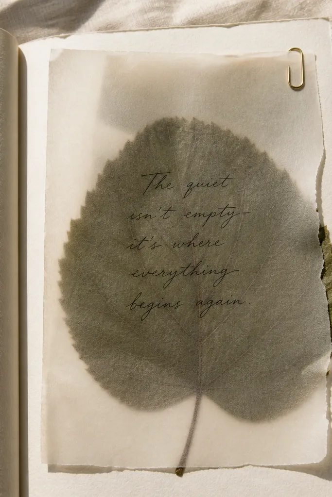 Pressed leaf under a sheet of vellum with a handwritten quote