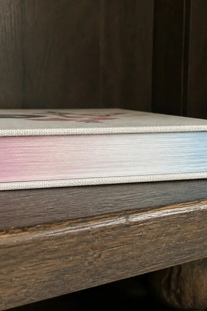 Book page edges painted in a soft blush color with clean lines