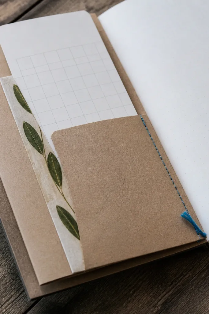 Kraft pocket along the page edge with a folded note sticking out