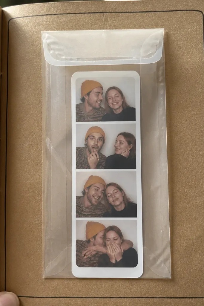 Small envelope on scrapbook page made from clear packaging with a strip inside